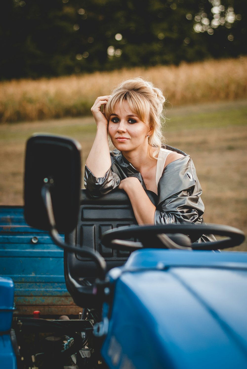 woman in black and white stripe shirt sitting on blue and black ride on toy car