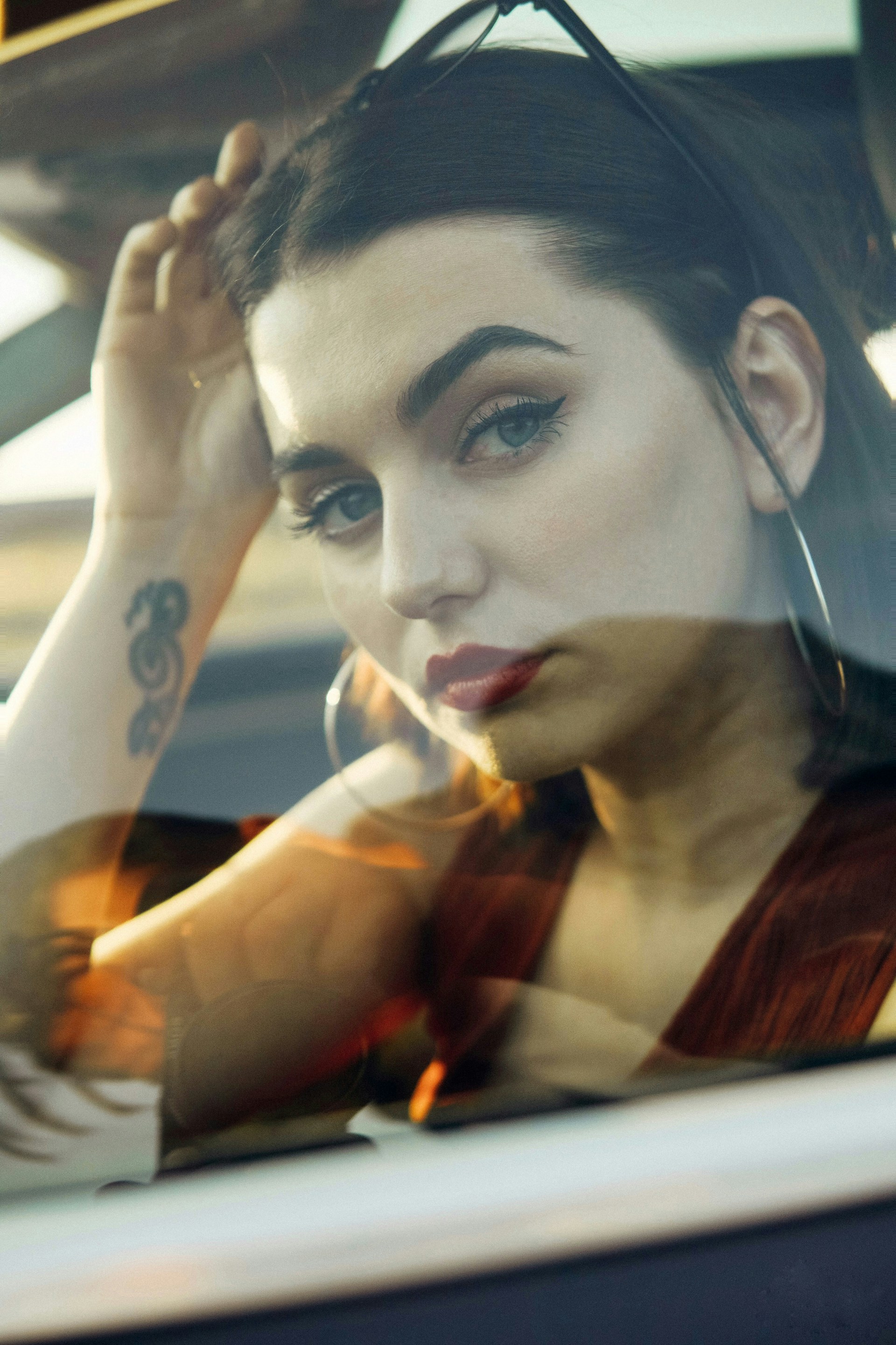 woman in red shirt holding cigarette stick