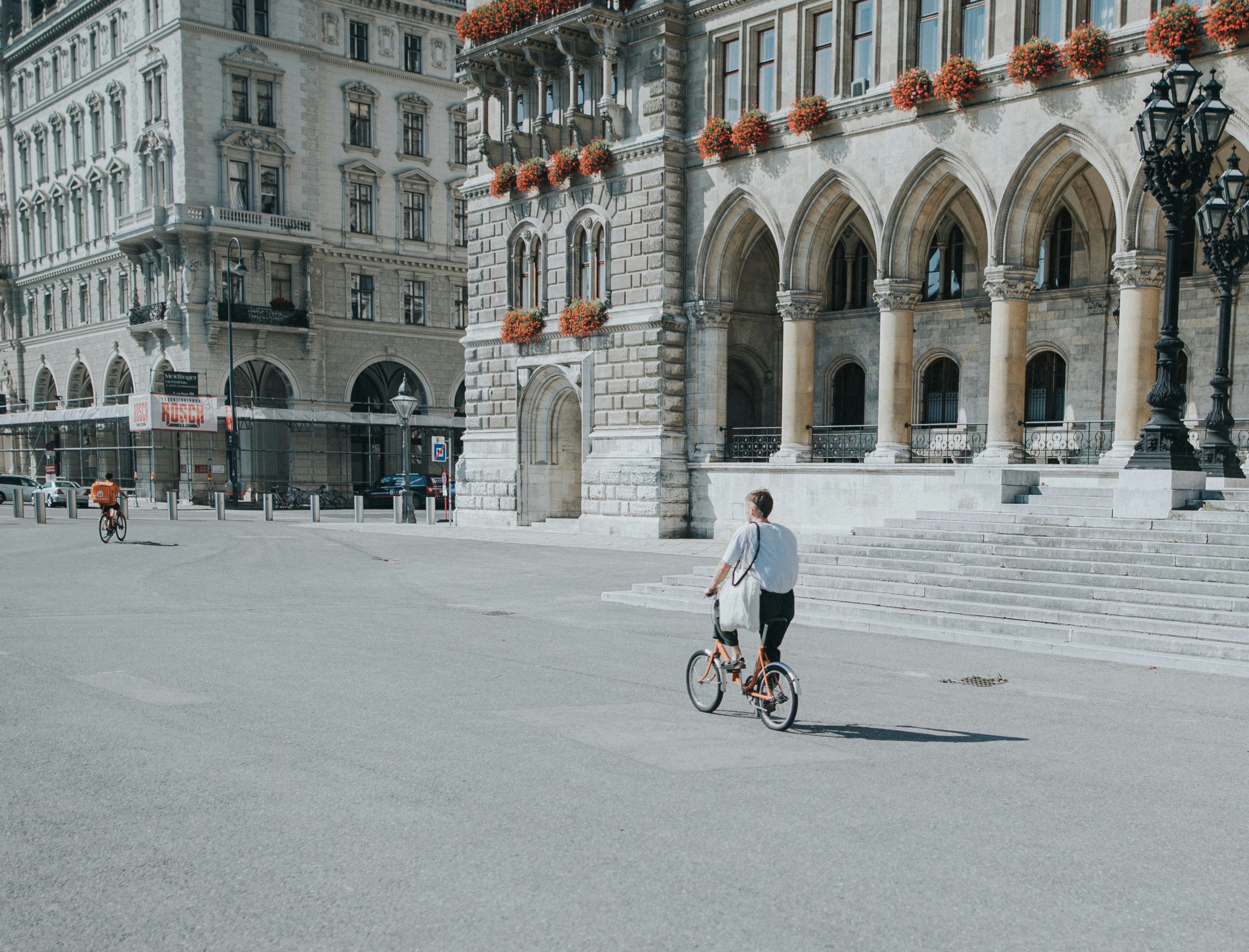 man in white shirt riding bicycle on road during daytime, 