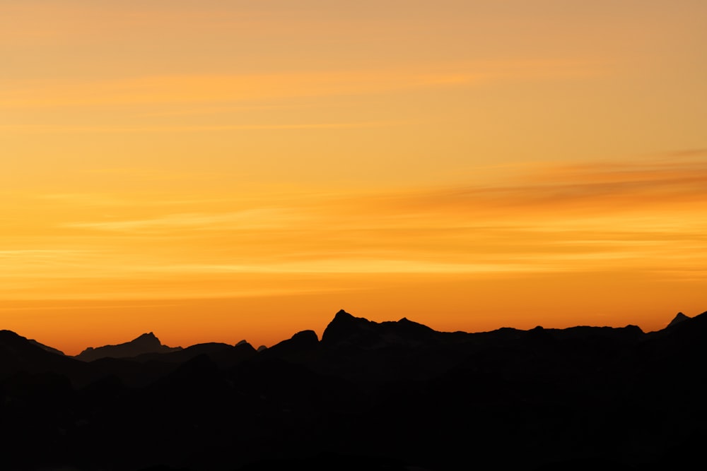 silhouette of mountains during sunset