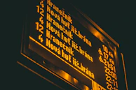 A modern digital schedule board listing the 8 programs in neon green on black.