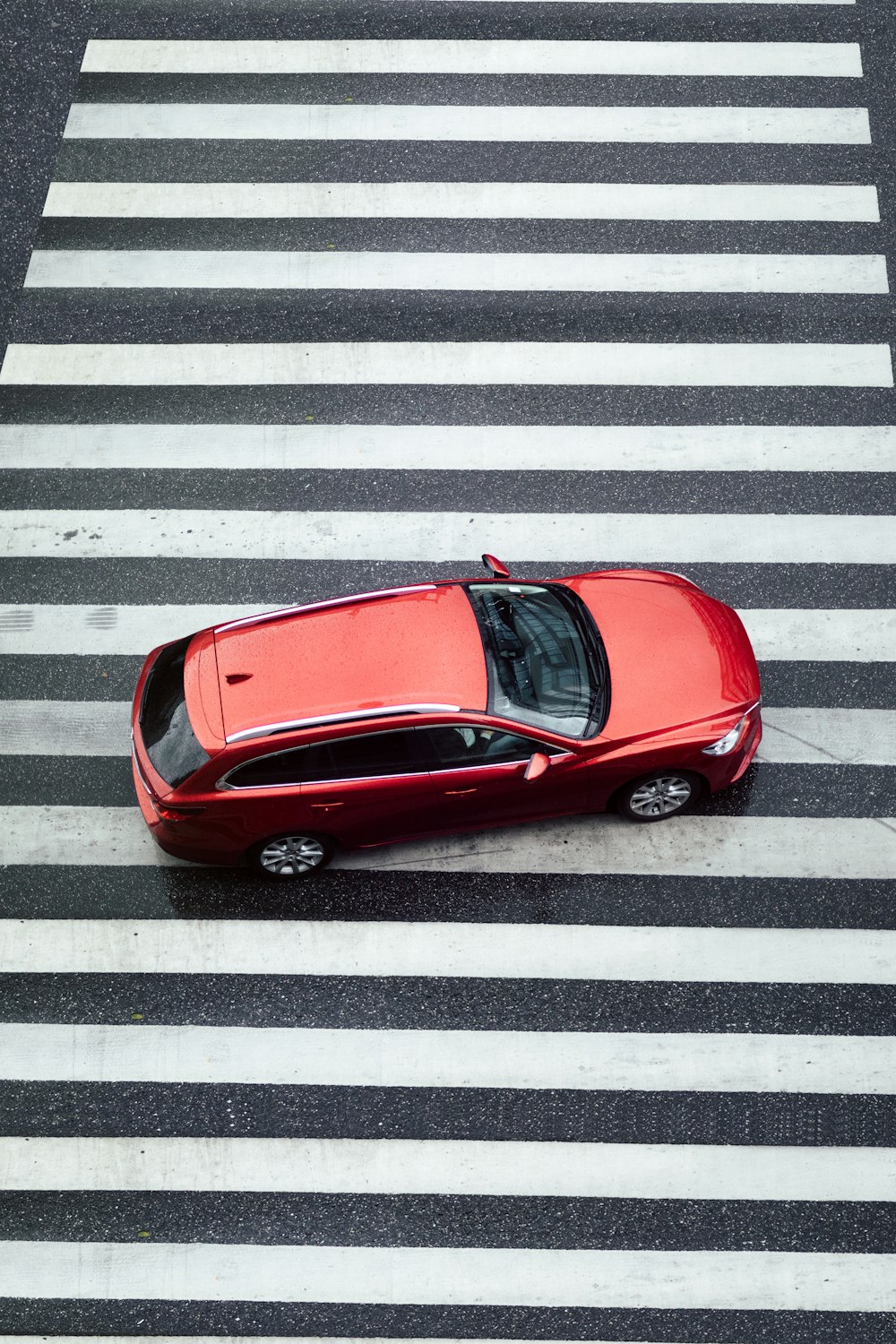 red car parked on pedestrian lane