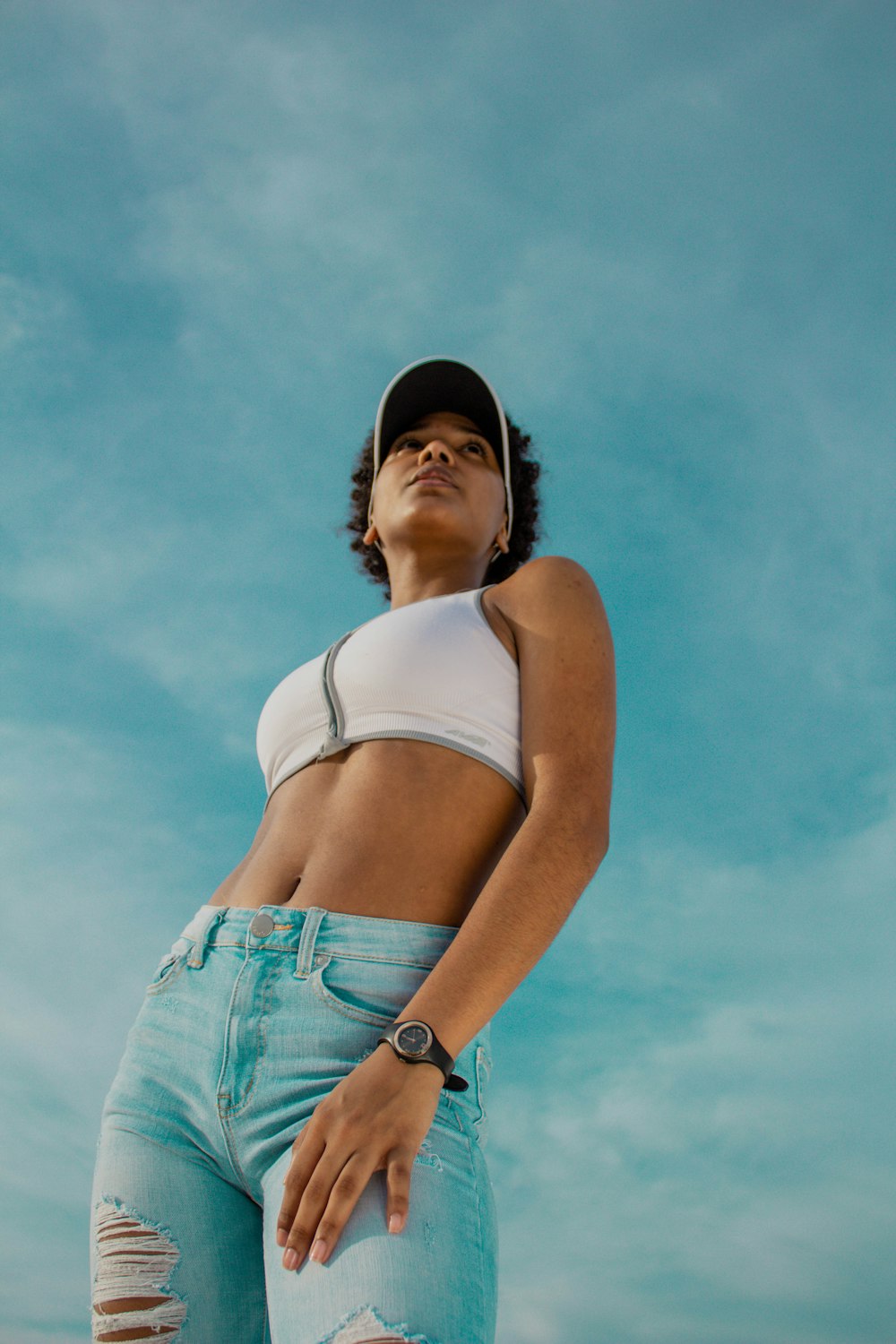 woman in white tank top and blue denim shorts