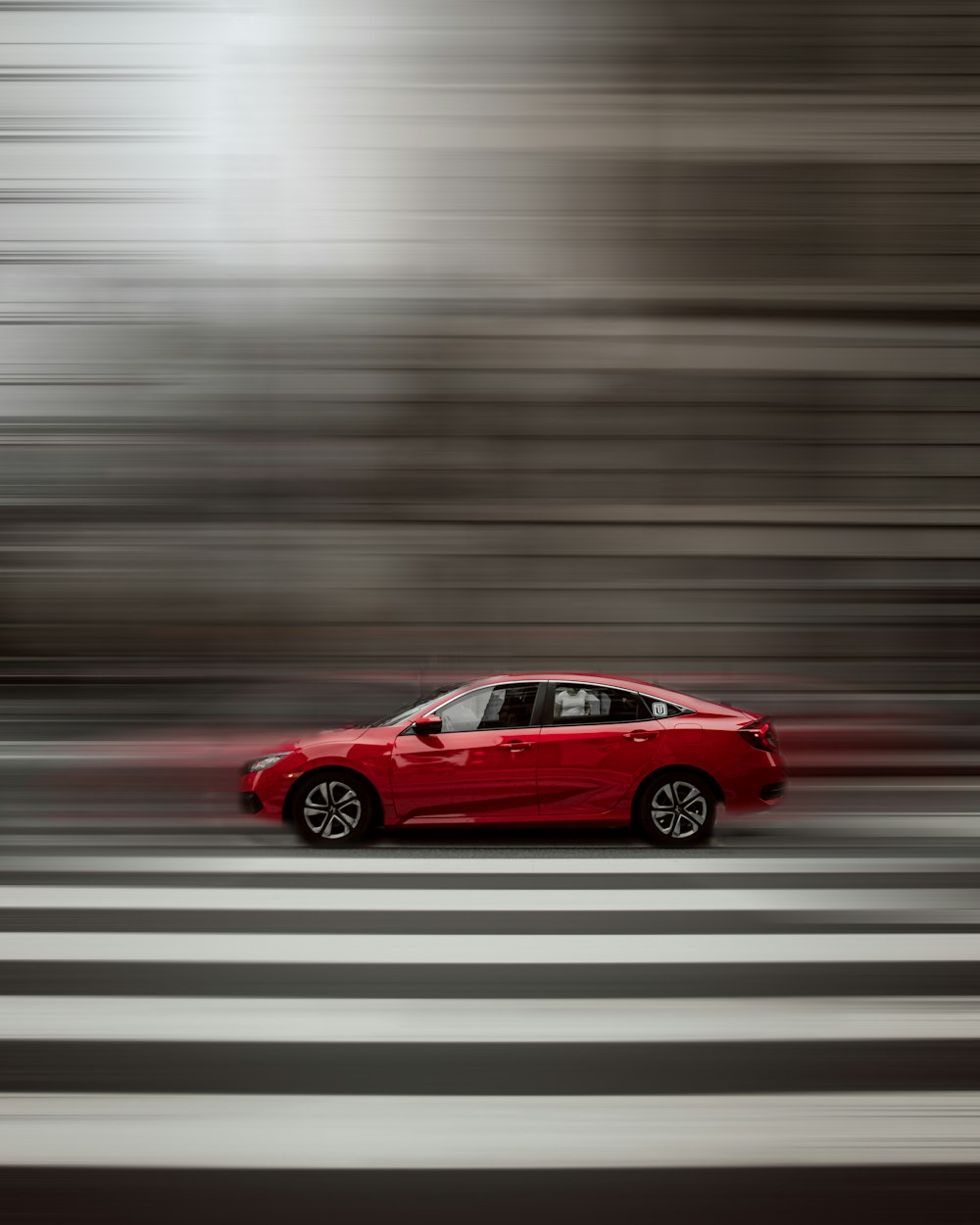 red sedan on road during daytime