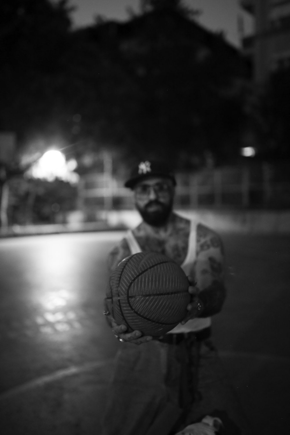 man in black and white tank top holding basketball