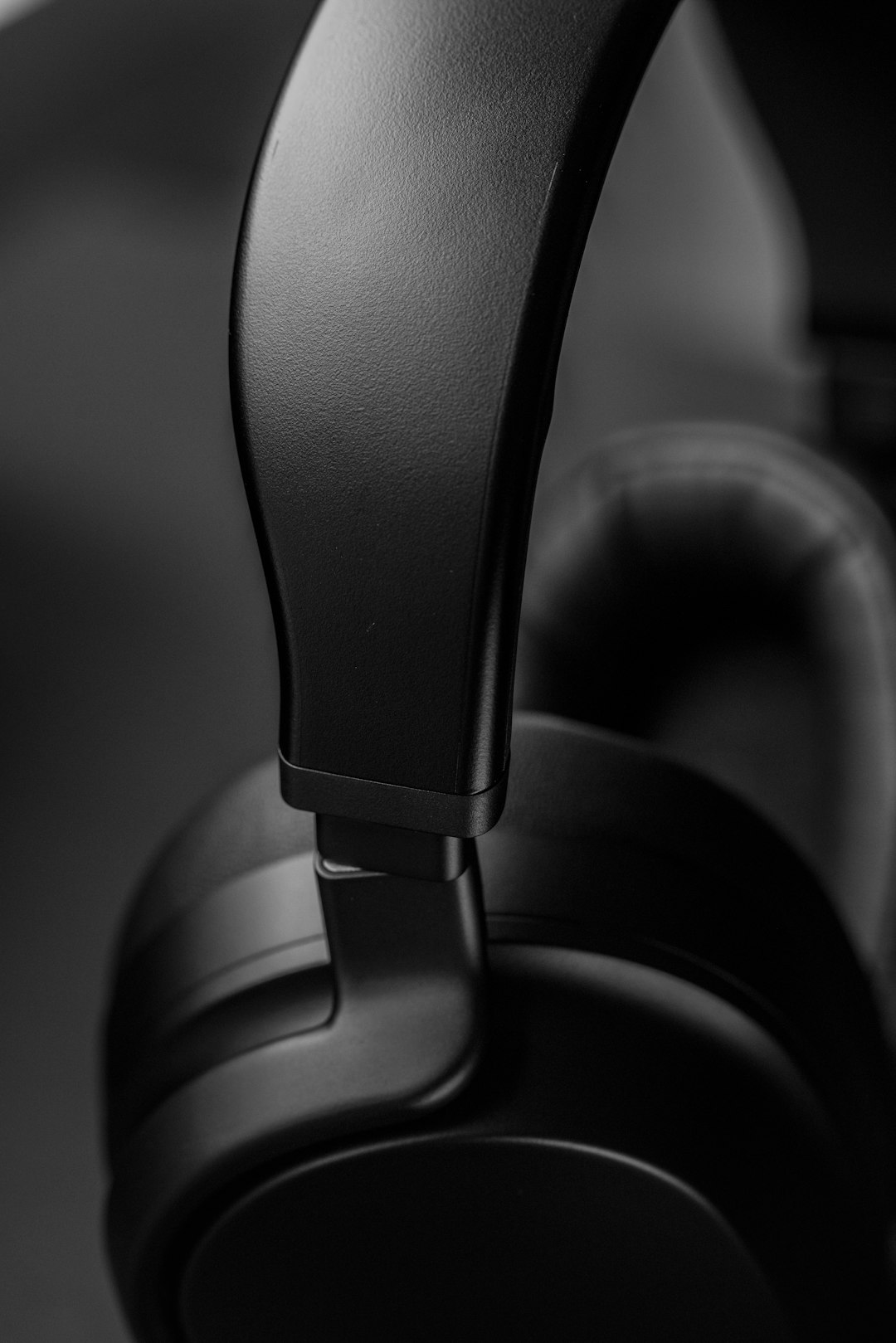 black and gray headphones on black surface