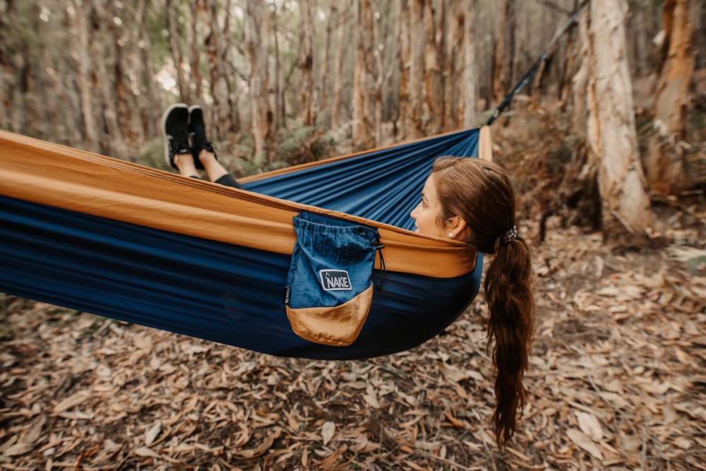 woman in black shirt lying on hammock