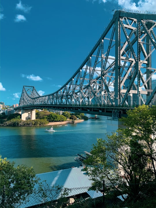 gray metal bridge over river under blue sky during daytime in Story Bridge Australia