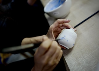 person holding white ceramic mug