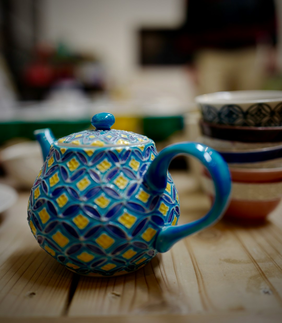 blue and white ceramic teapot on brown wooden table