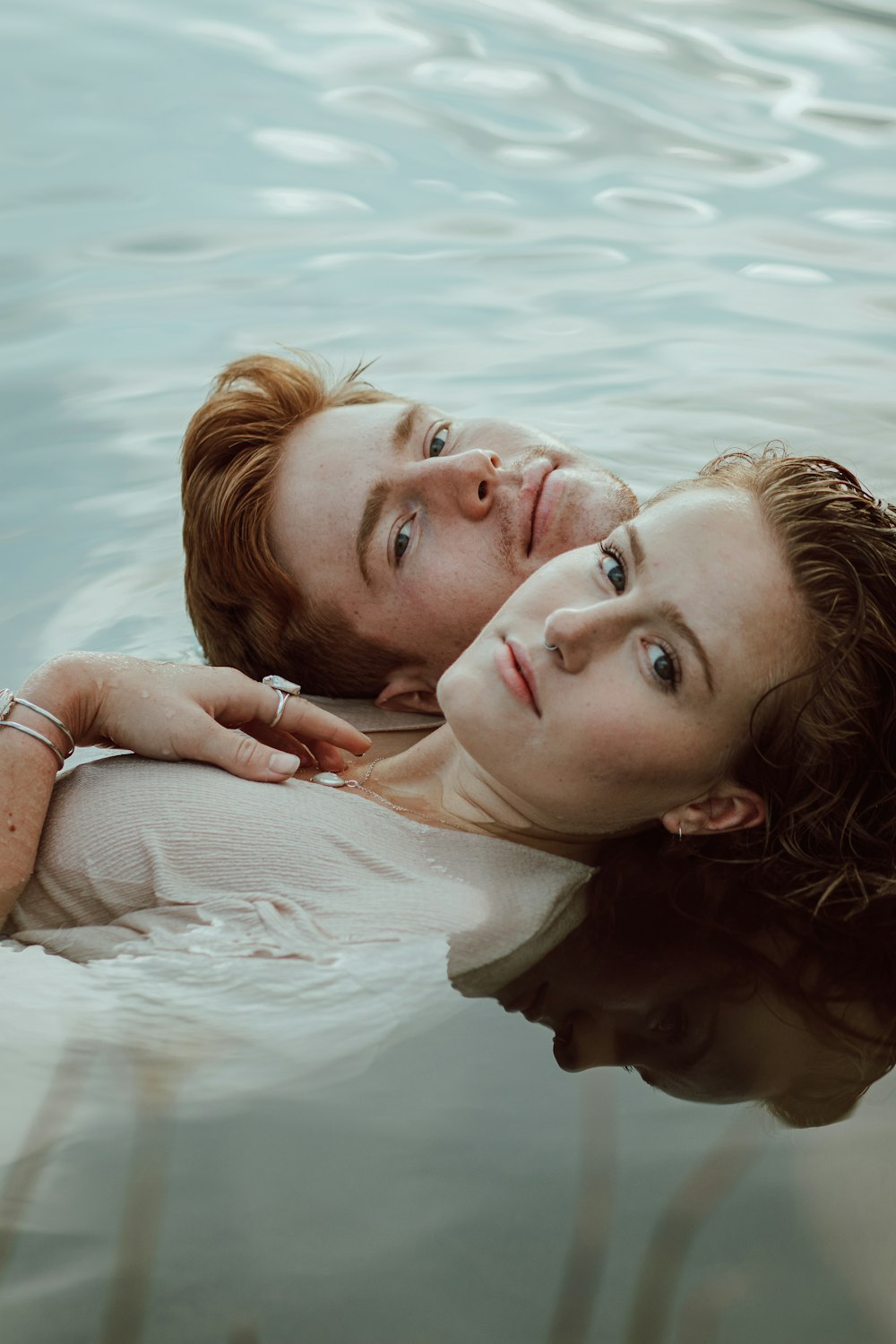 woman in white shirt lying on water