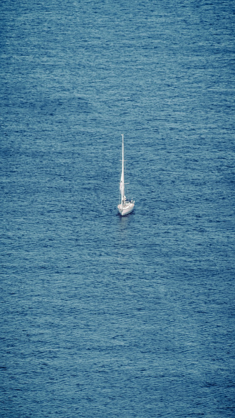 white sailboat on blue sea during daytime