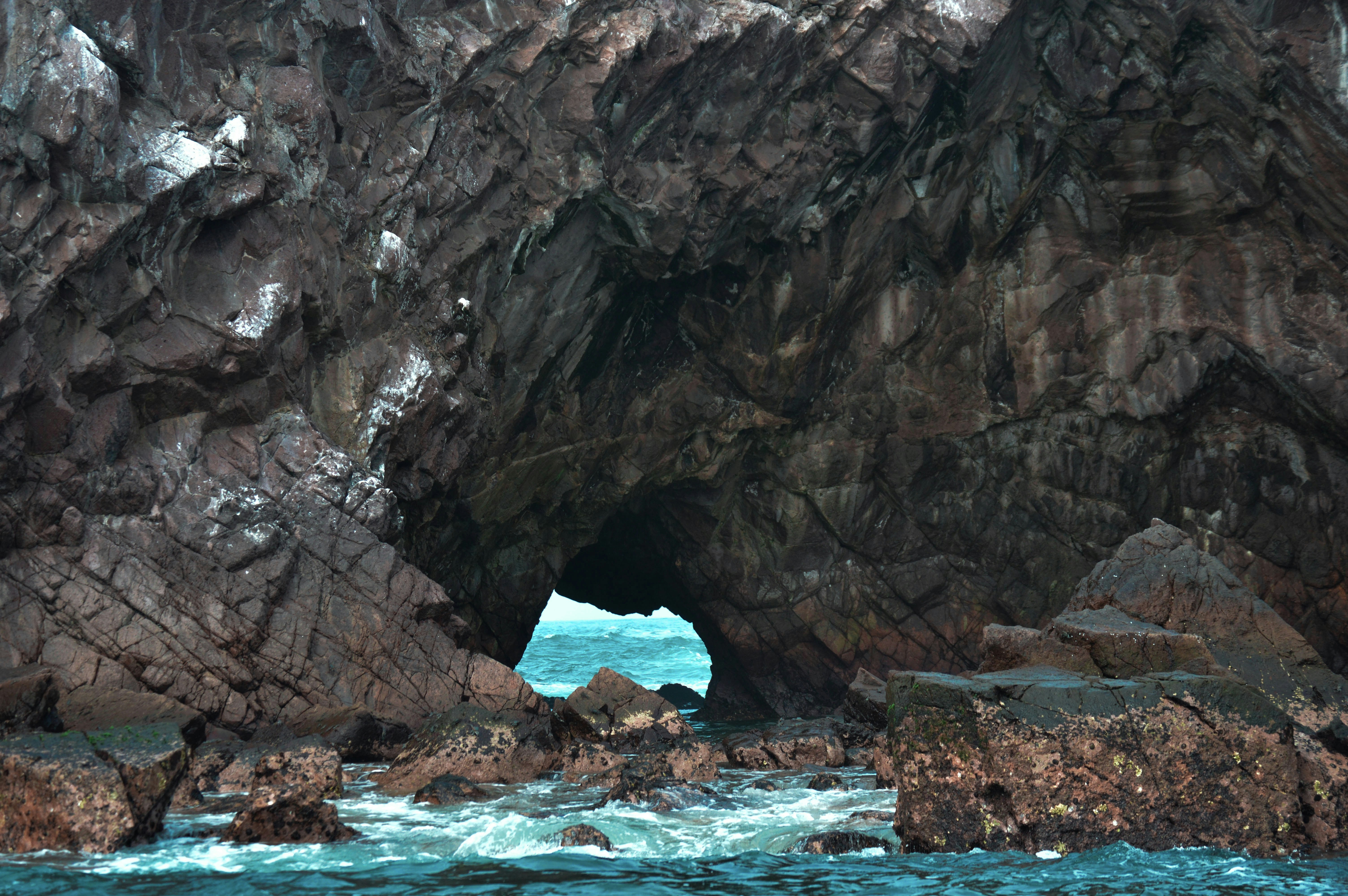 brown rock formation on blue sea during daytime, 