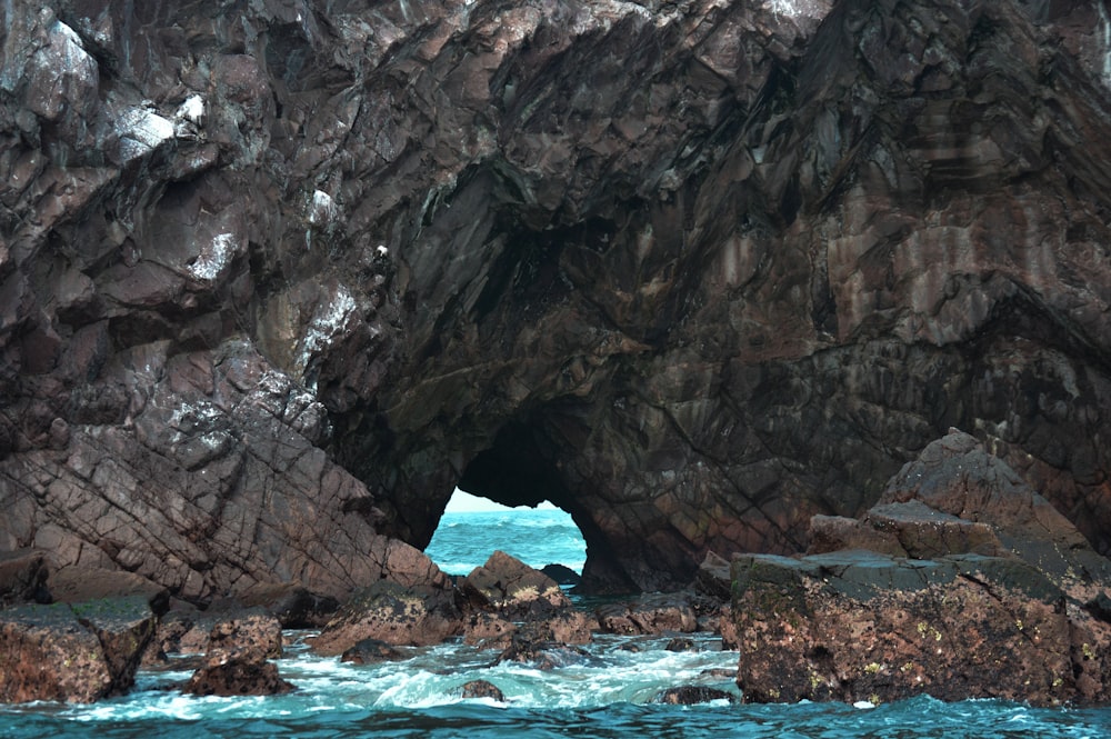 brown rock formation on blue sea during daytime