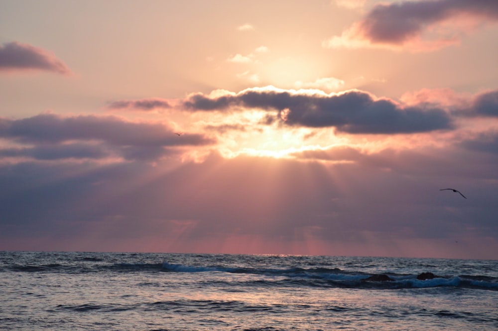 ocean waves under cloudy sky during daytime