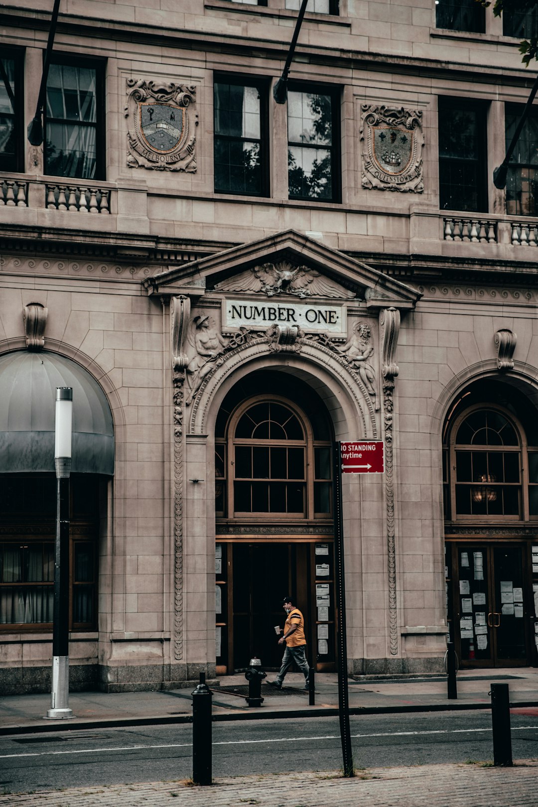 people walking in front of gray concrete building during daytime