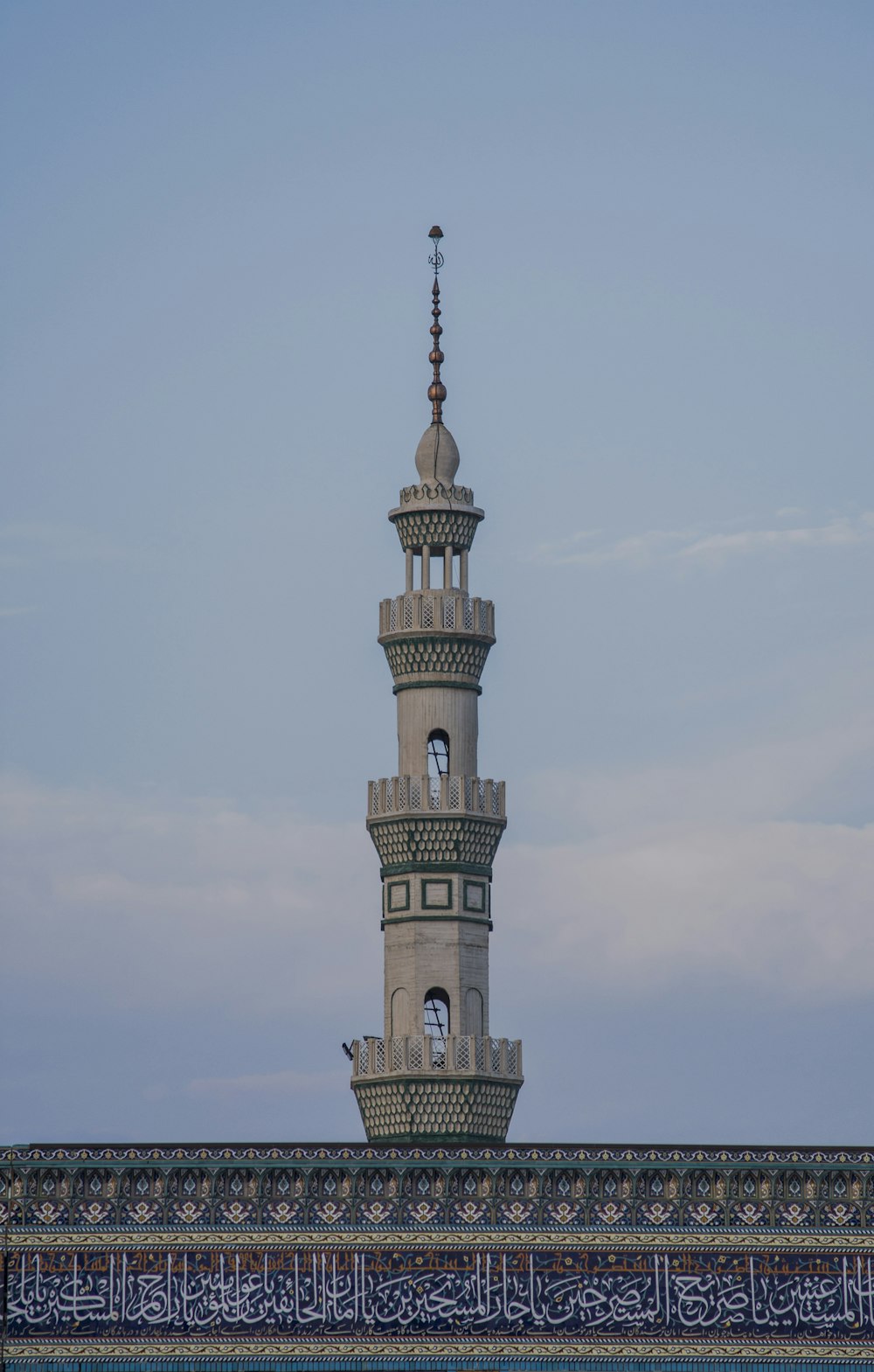 white concrete tower under white clouds during daytime