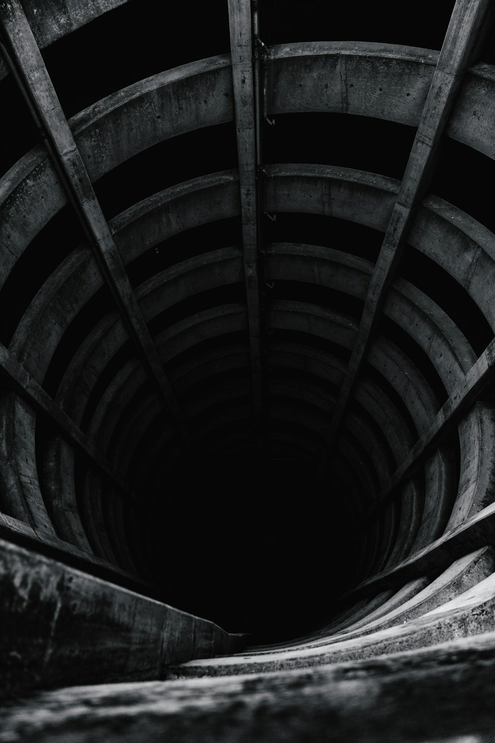 grayscale photo of wooden tunnel