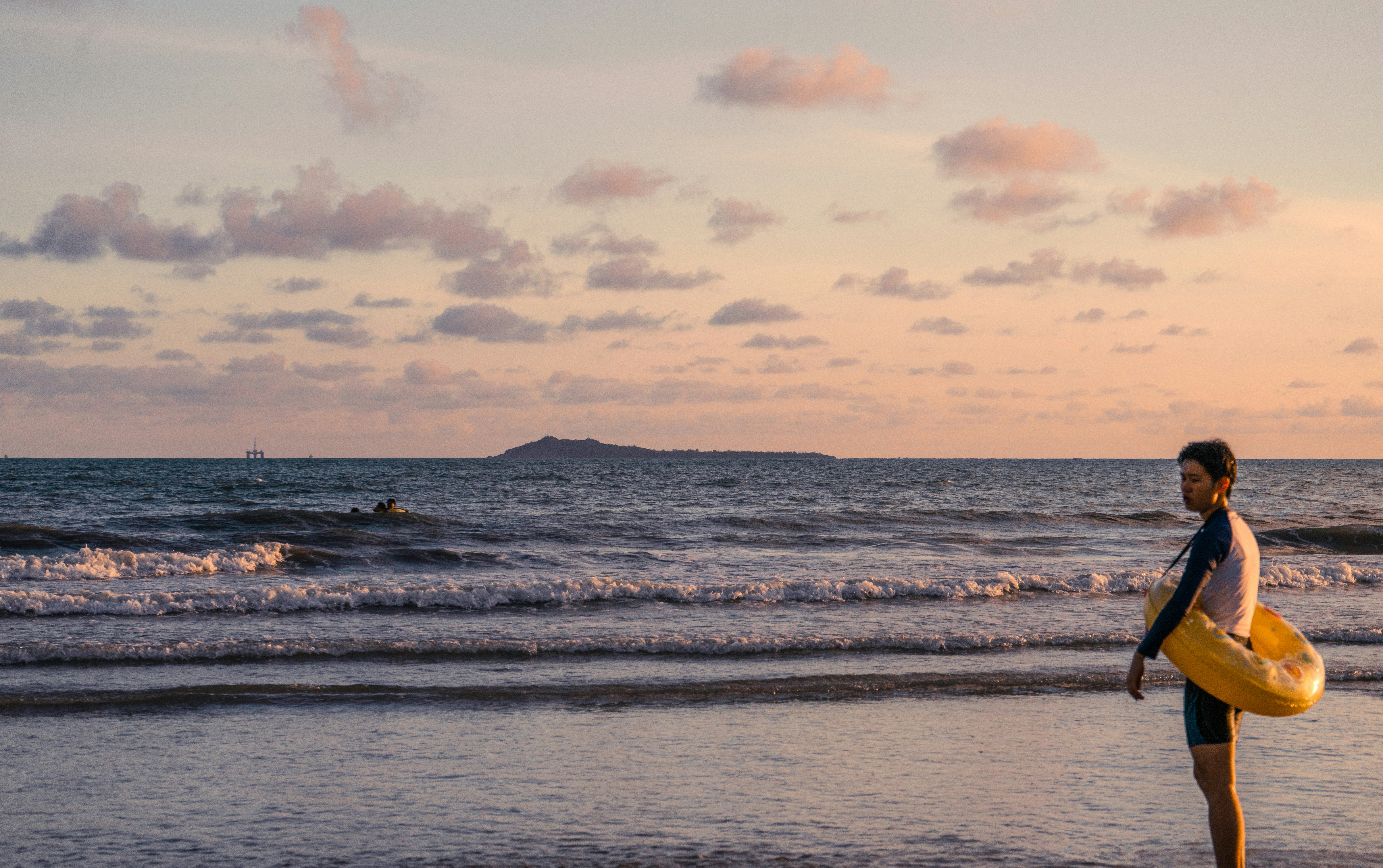 Океанские волны разбиваются о берег на закате