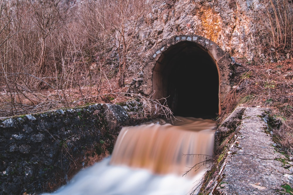 brown rock formation with water falls