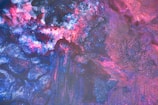 Close-up of vibrant pink and purple slime swirled together with glitter.