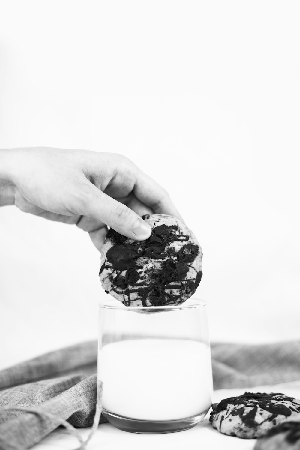 grayscale photo of person holding ice cream cone