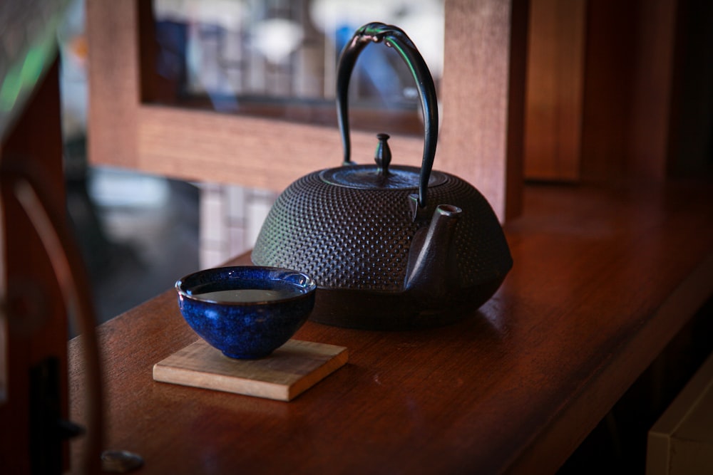 black teapot on brown wooden table