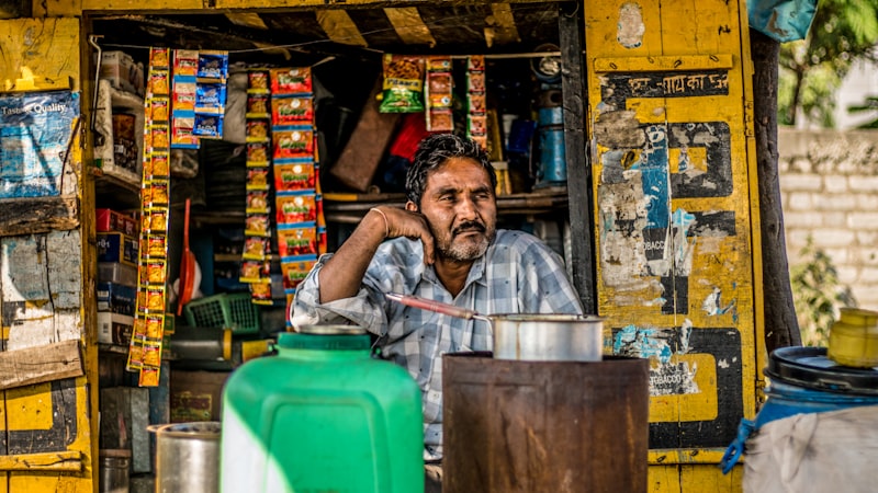 Small shop owner sitting in kirana shop India