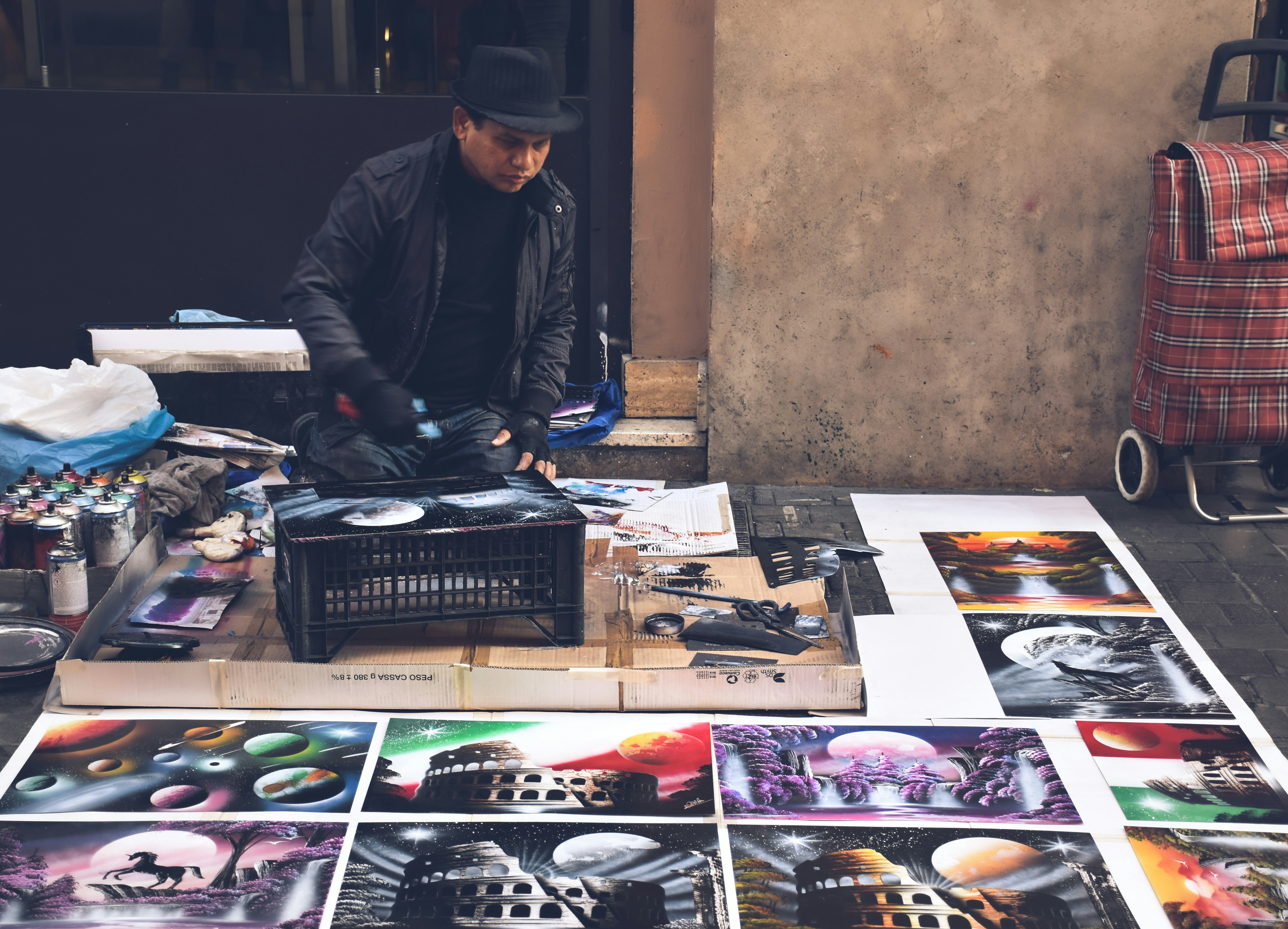 man in black jacket and black hat sitting on chair