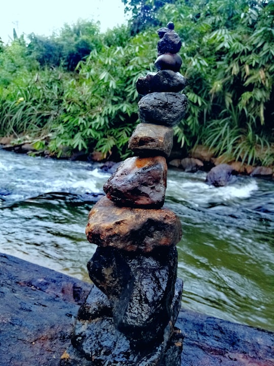 gray and brown stone near body of water during daytime in Sabaragamuwa Province Sri Lanka