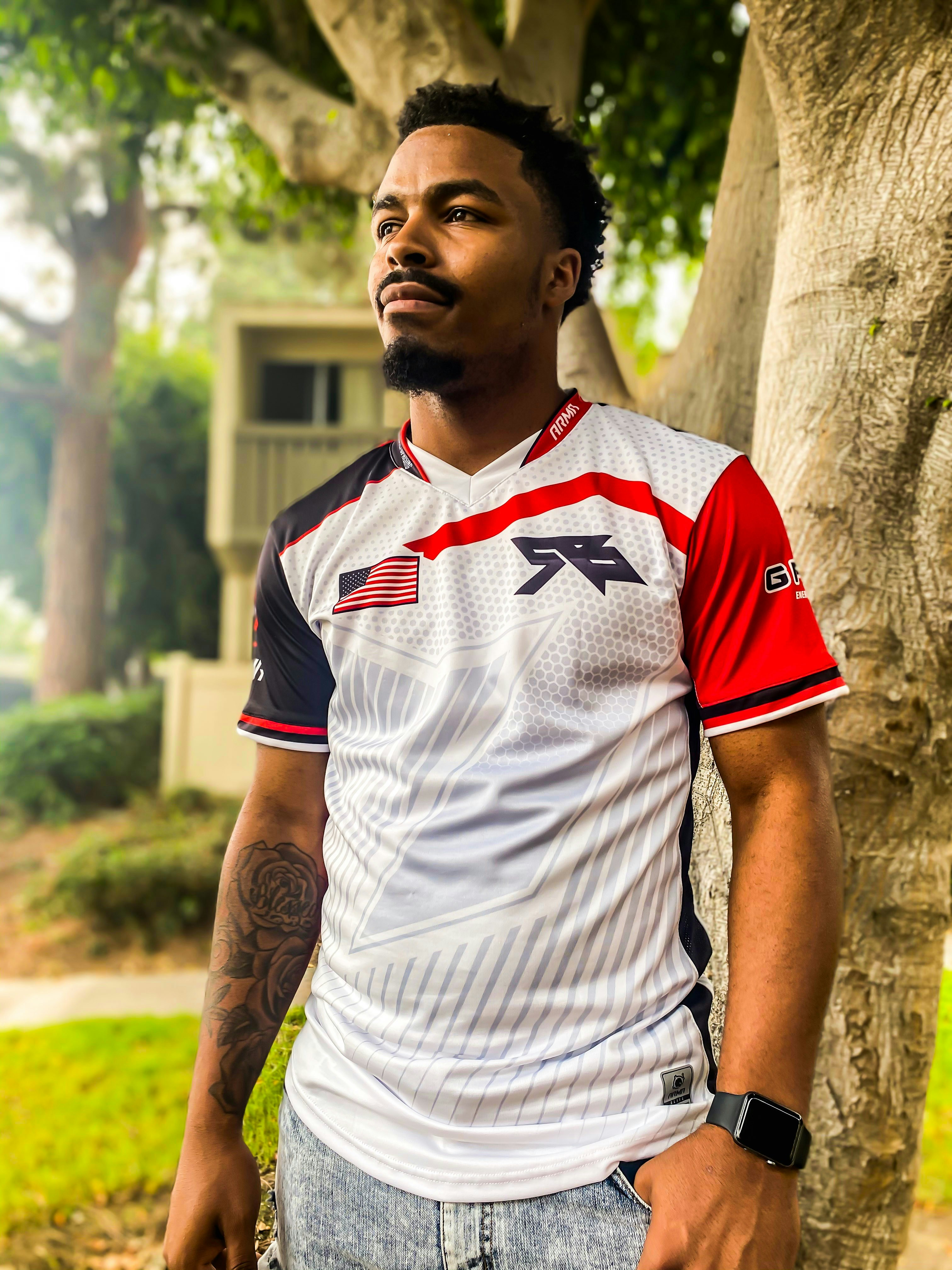 a man standing in front of a tree