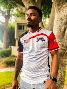 a man standing in front of a tree