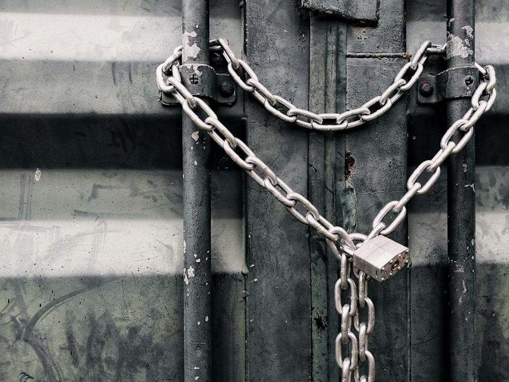 gray metal chain on green metal door