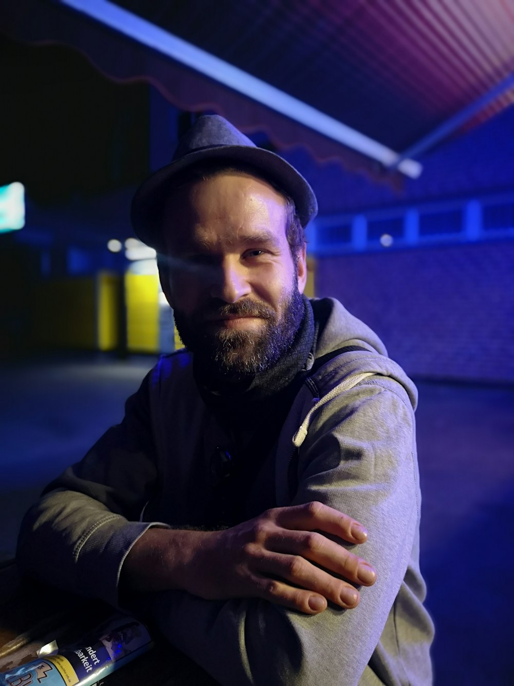 man in gray hoodie and black cap