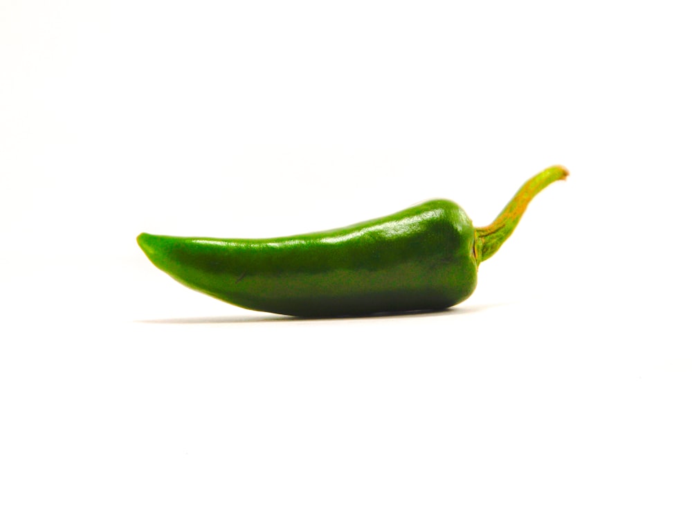 green chili on white surface