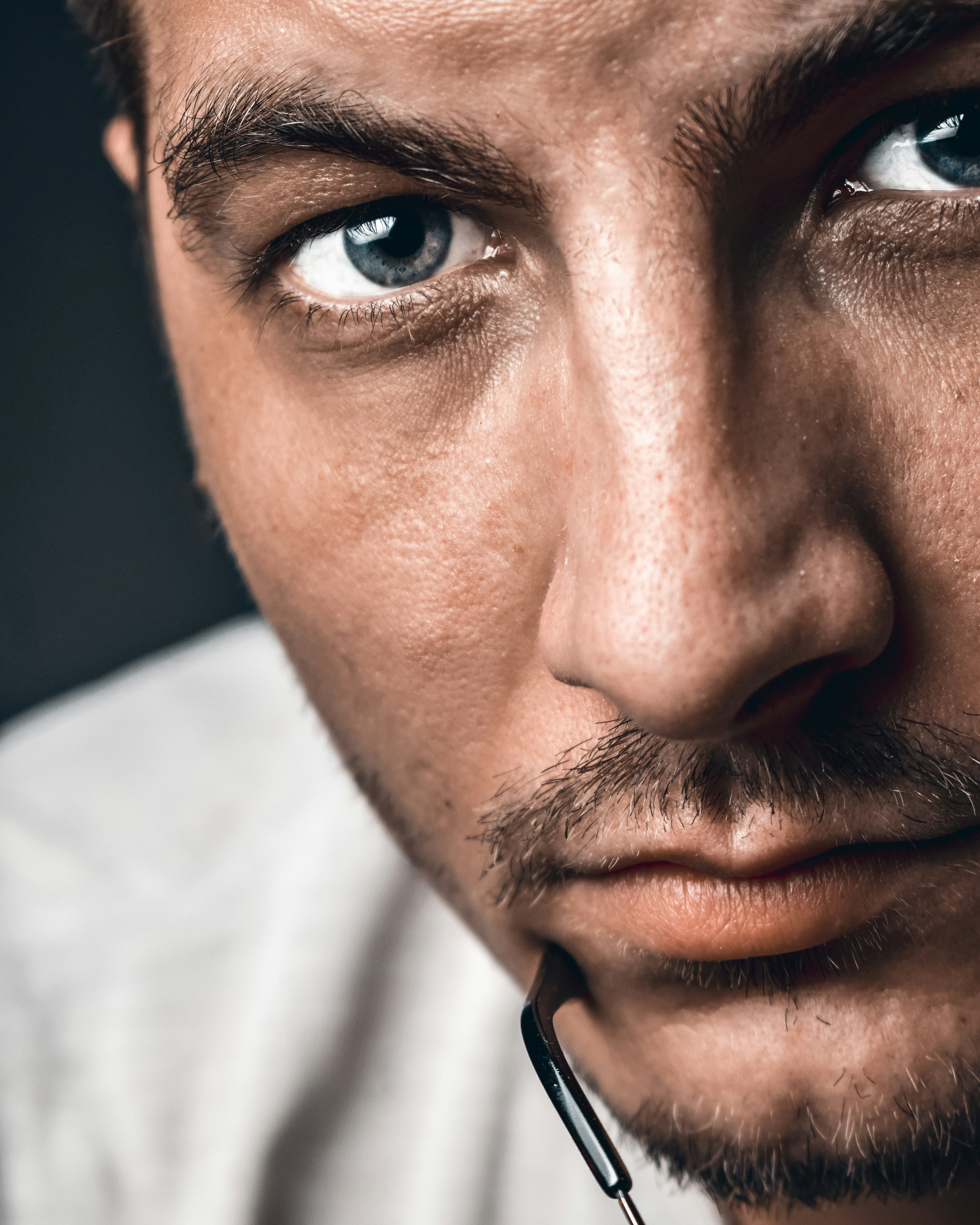 man in white shirt wearing black earbuds