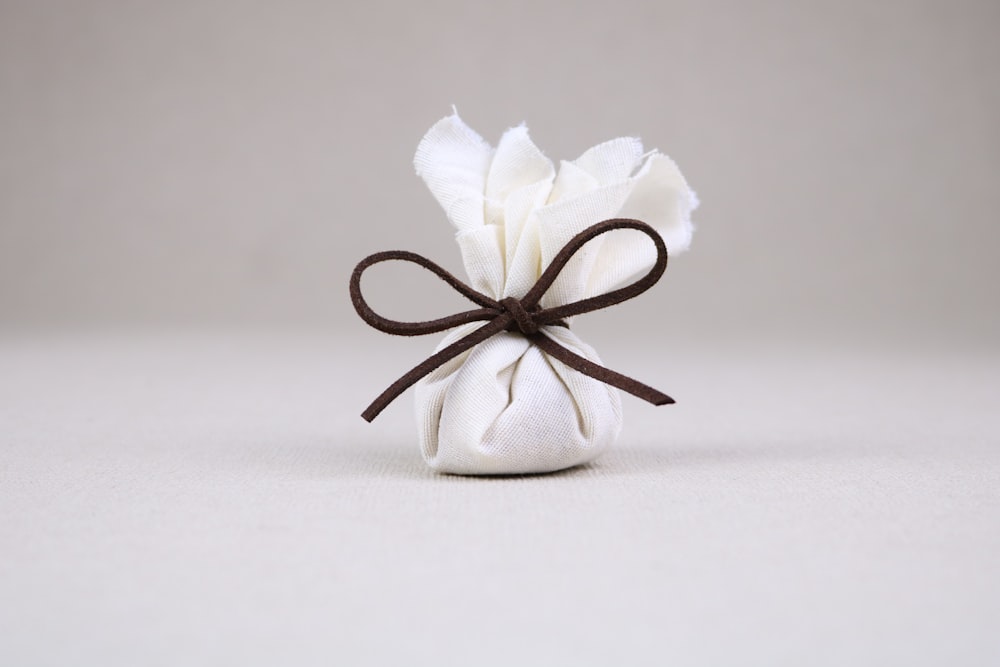 white and black ribbon on white textile