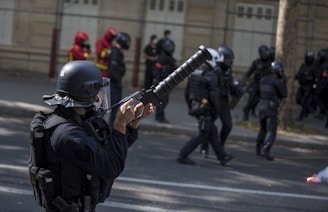 man in black leather jacket holding rifle