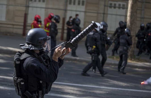 man in black leather jacket holding rifle