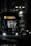 A tram with a digital display showing 'Hiroshima Port' is stationary at a stop during nighttime. The headlights of the tram are on, illuminating part of the scene. A person wearing a mask stands at the tram stop, looking at a mobile device, while another person is visible inside the tram.