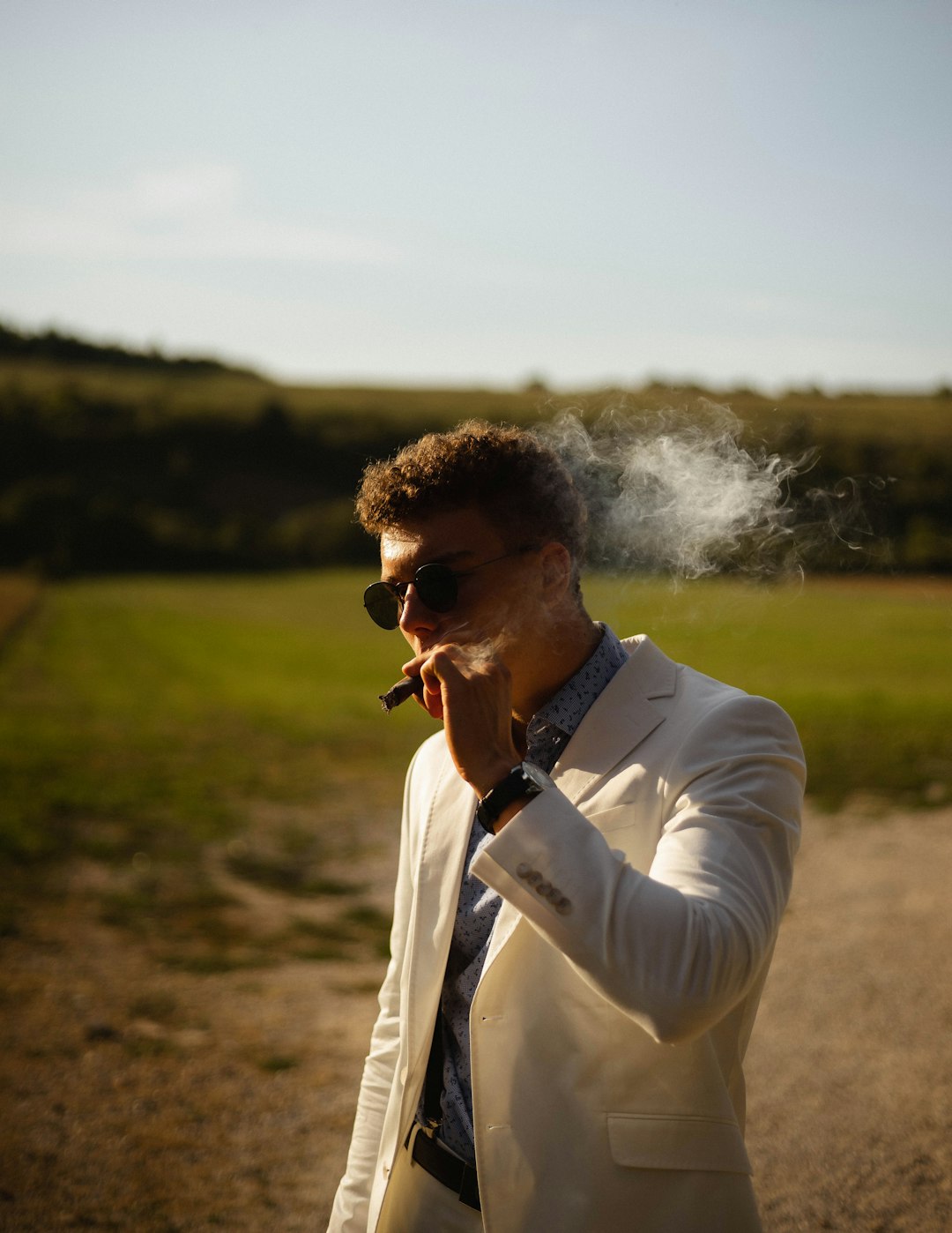 man in white dress shirt smoking