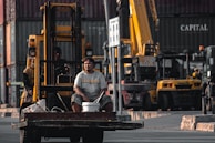 A forklift expertly lifting heavy materials on a busy construction site in Abu Dhabi.