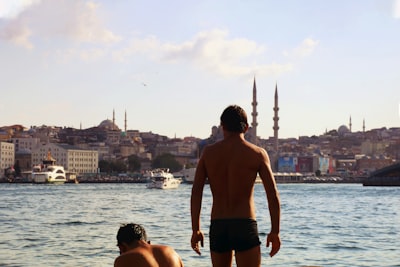 man in black shorts standing beside woman in black shorts back zoom background