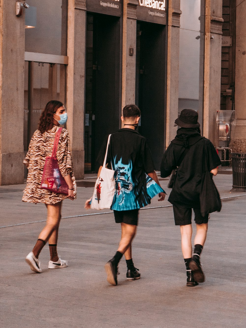 2 girls in green and black dress walking on sidewalk during daytime