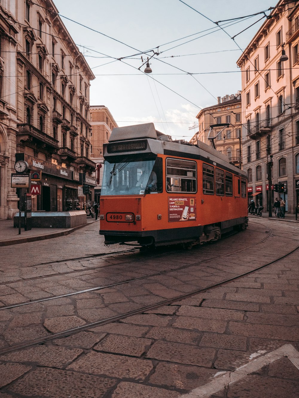 red and white tram on road during daytime