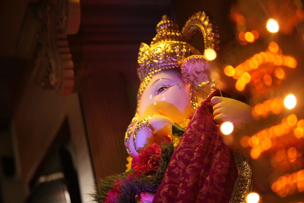 gold and red hindu deity figurine