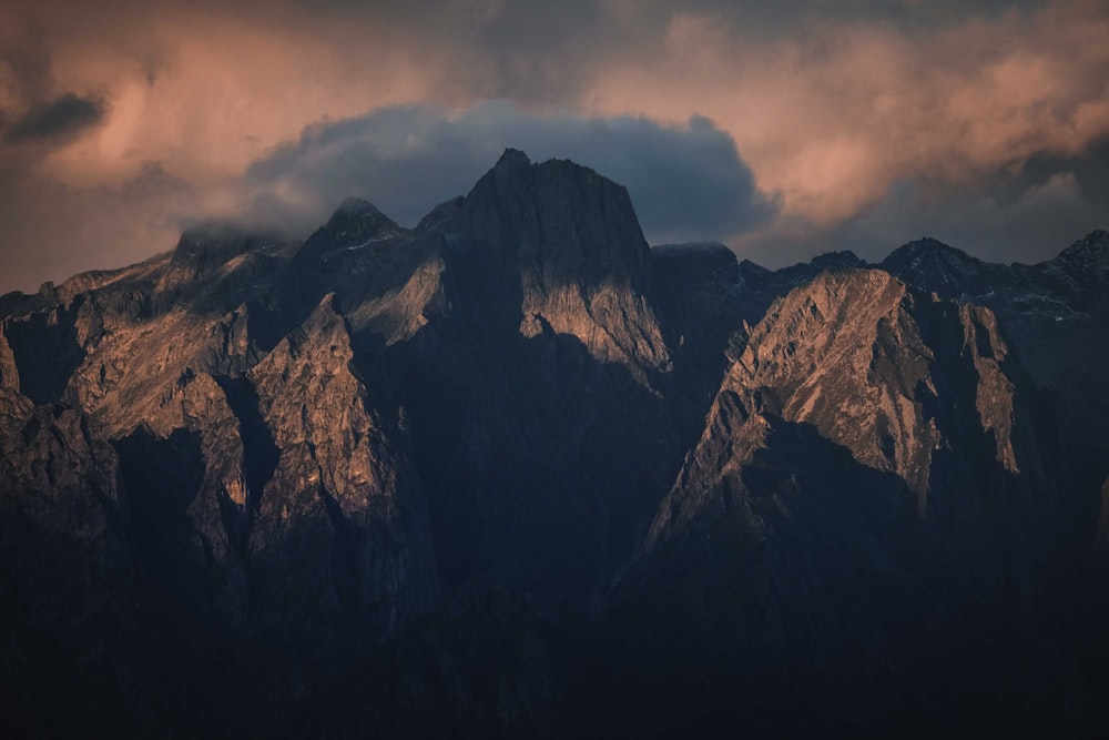 brown rocky mountain under cloudy sky during daytime