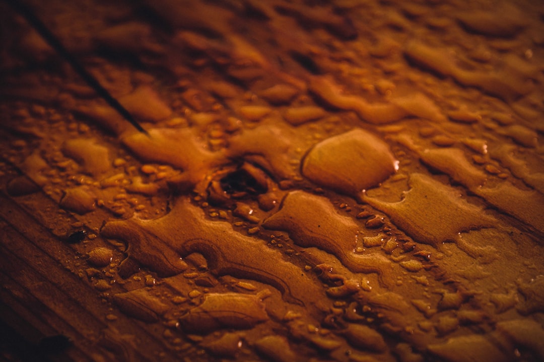 water droplets on brown surface