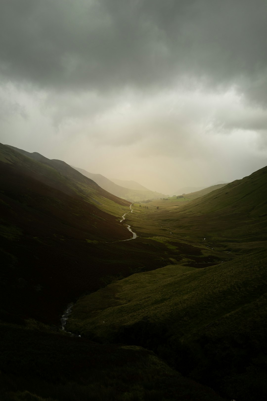 green mountains under white clouds during daytime