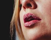 Woman's lips dusted with sweetener crystals — TasteBlend Adorvia Reb M, clean sweetness